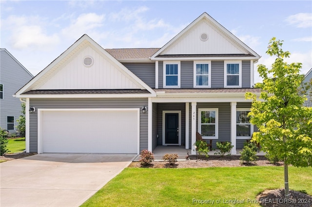 view of front of home featuring a garage and a front lawn