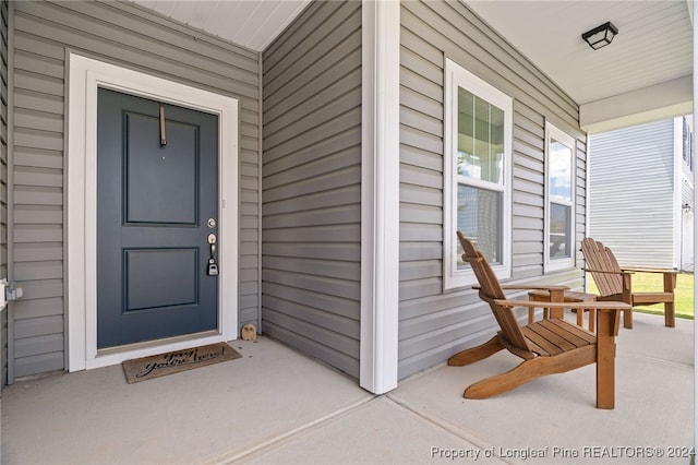 view of exterior entry featuring a porch