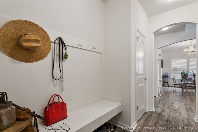 mudroom with hardwood / wood-style flooring and a chandelier