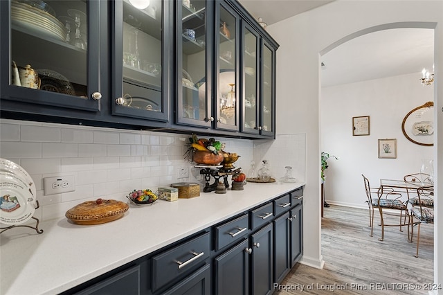 bar with backsplash and hardwood / wood-style flooring