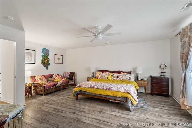 bedroom with ceiling fan and hardwood / wood-style floors