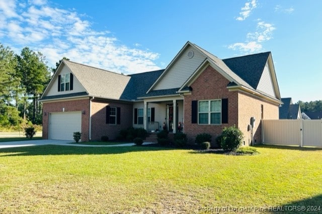 view of front of property featuring a front yard and a garage