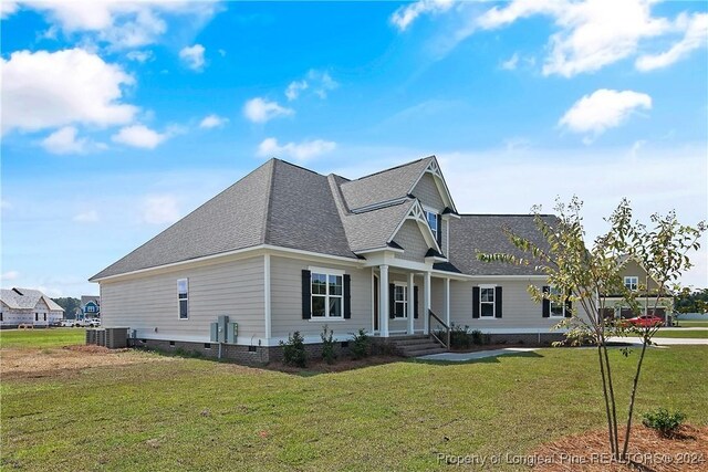 view of front of home featuring cooling unit, a front yard, and a porch