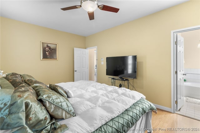 bedroom featuring light hardwood / wood-style flooring, connected bathroom, and ceiling fan