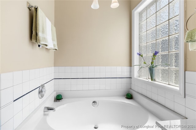 bathroom with a tub to relax in