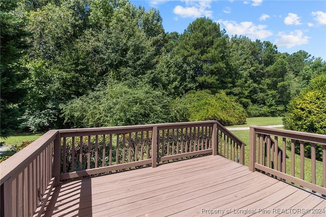 wooden deck featuring a yard