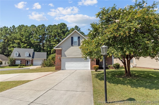 view of front of property featuring a garage and a front lawn