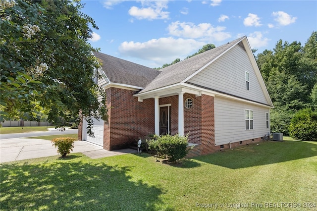 view of home's exterior featuring a yard and central AC unit