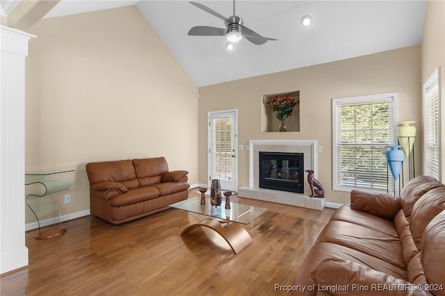 living room with high vaulted ceiling, hardwood / wood-style floors, ceiling fan, and a fireplace