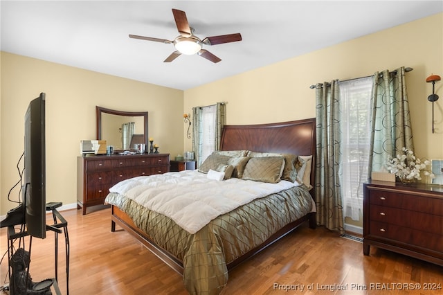 bedroom with wood-type flooring and ceiling fan