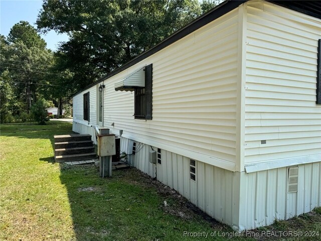 1644 Henry Berry Rd 1642, Rowland, NC 28383 - view of property exterior featuring a lawn