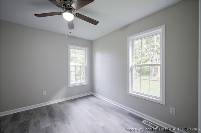 spare room featuring hardwood / wood-style flooring and ceiling fan