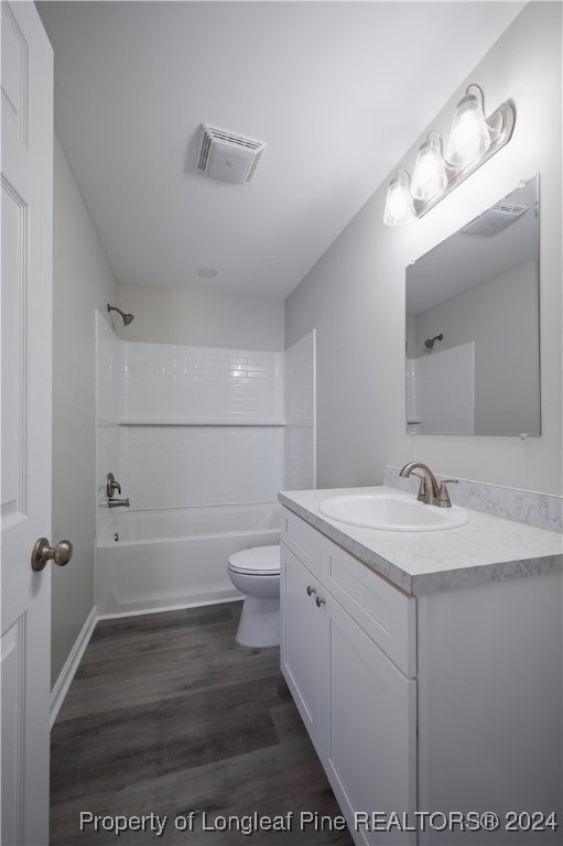 full bathroom with vanity, toilet, wood-type flooring, and shower / washtub combination