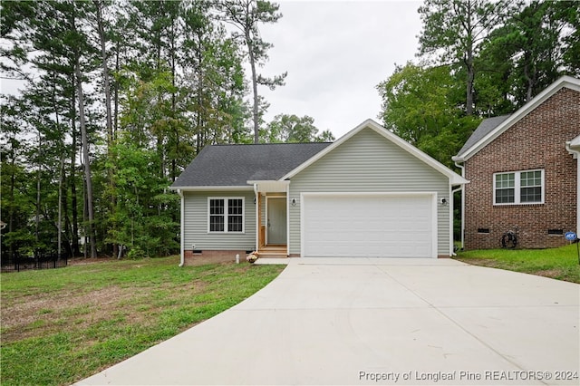 view of front of house with a garage and a front lawn