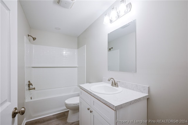 full bathroom featuring vanity, toilet, washtub / shower combination, and hardwood / wood-style floors