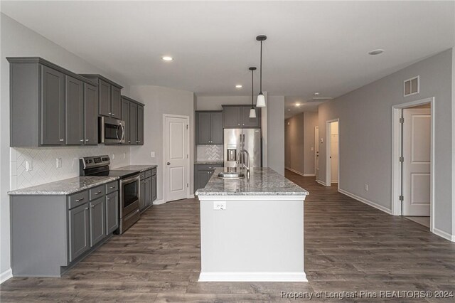 kitchen featuring light stone counters, sink, dark hardwood / wood-style floors, appliances with stainless steel finishes, and gray cabinetry