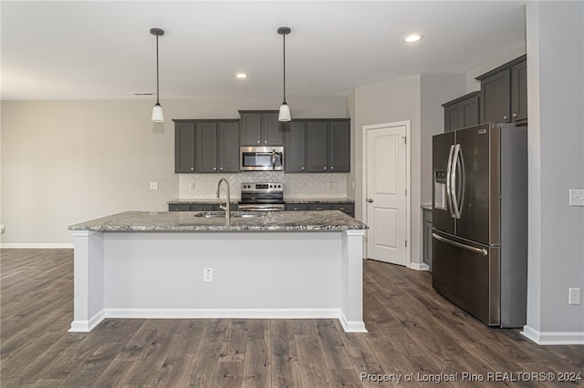 kitchen with sink, decorative light fixtures, appliances with stainless steel finishes, and dark hardwood / wood-style flooring