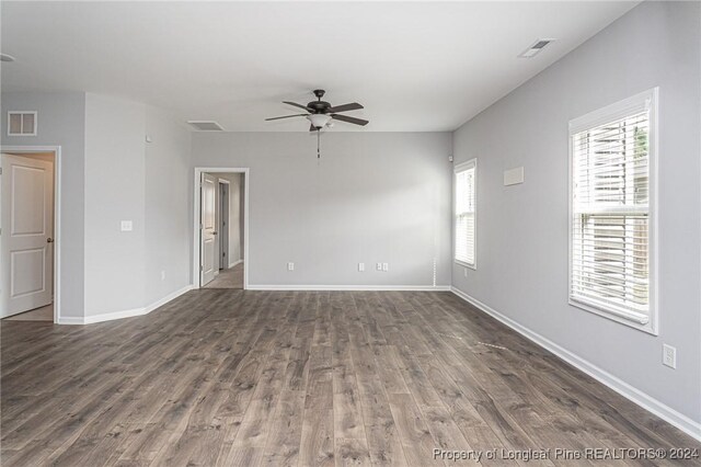 empty room featuring ceiling fan and dark hardwood / wood-style floors