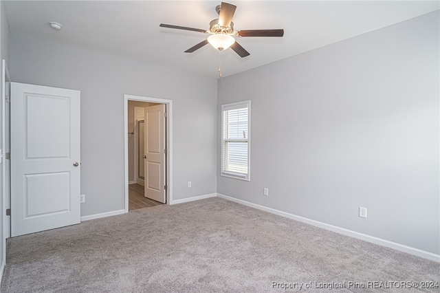 unfurnished bedroom featuring light carpet and ceiling fan