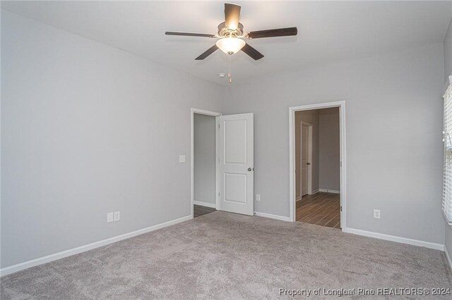 unfurnished bedroom featuring ceiling fan and carpet