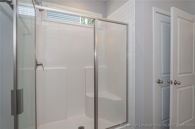 bathroom featuring an enclosed shower