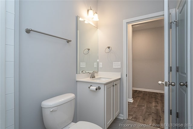 bathroom featuring vanity, toilet, and wood-type flooring