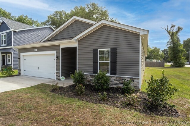 view of front of property with a front lawn and a garage