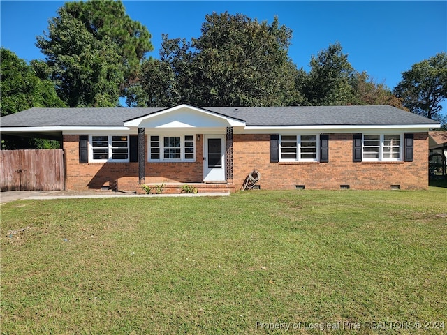 ranch-style home with a front lawn