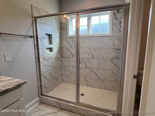 bathroom featuring vanity and an enclosed shower