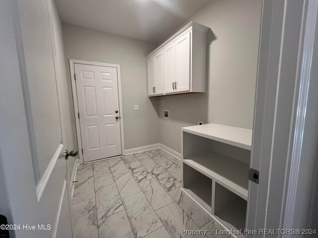 clothes washing area with washer hookup, electric dryer hookup, and cabinets