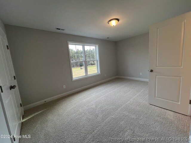 unfurnished bedroom featuring light colored carpet