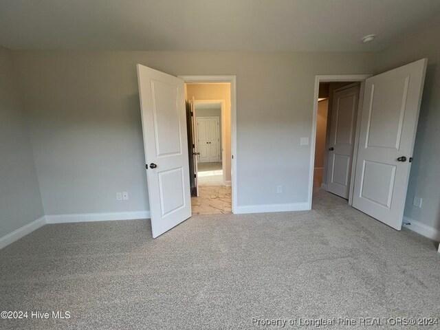 unfurnished bedroom with light carpet