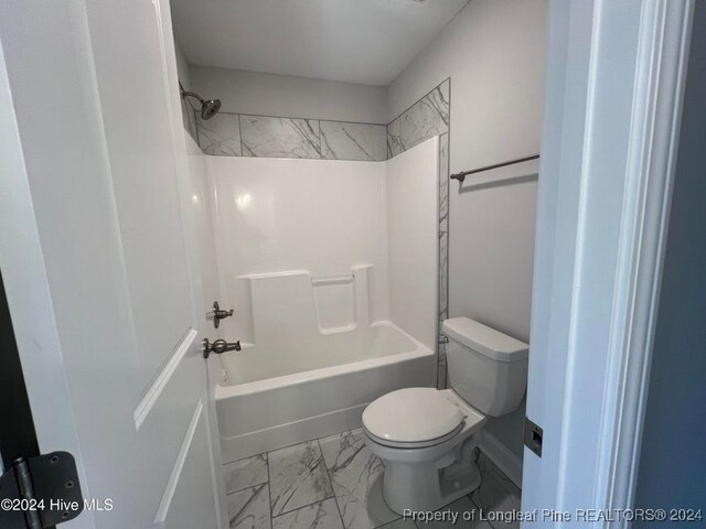 bathroom featuring toilet and shower / washtub combination