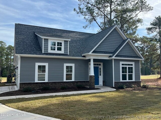 craftsman inspired home with a front yard