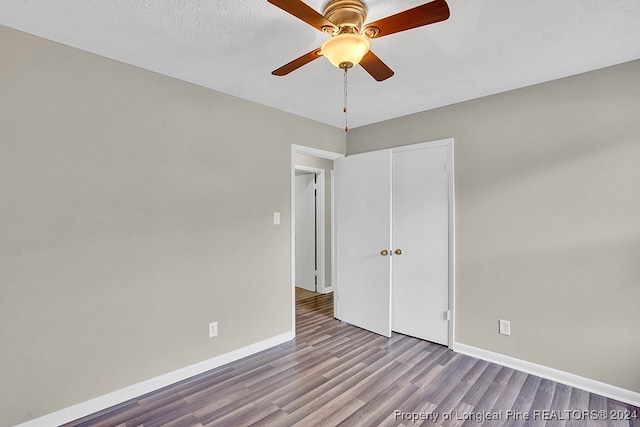 empty room with light wood-type flooring, a textured ceiling, and ceiling fan