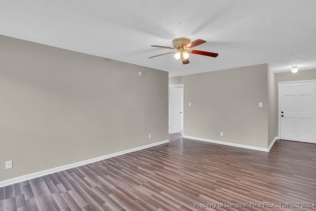 spare room featuring ceiling fan, a textured ceiling, and dark hardwood / wood-style floors