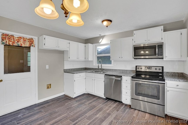 kitchen featuring backsplash, dark hardwood / wood-style floors, stainless steel appliances, and white cabinets