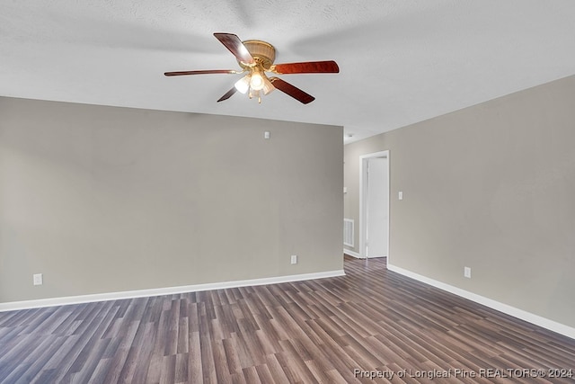 unfurnished room with a textured ceiling, ceiling fan, and dark hardwood / wood-style flooring