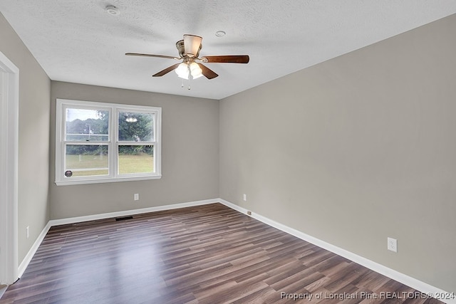 unfurnished room with a textured ceiling, dark hardwood / wood-style floors, and ceiling fan