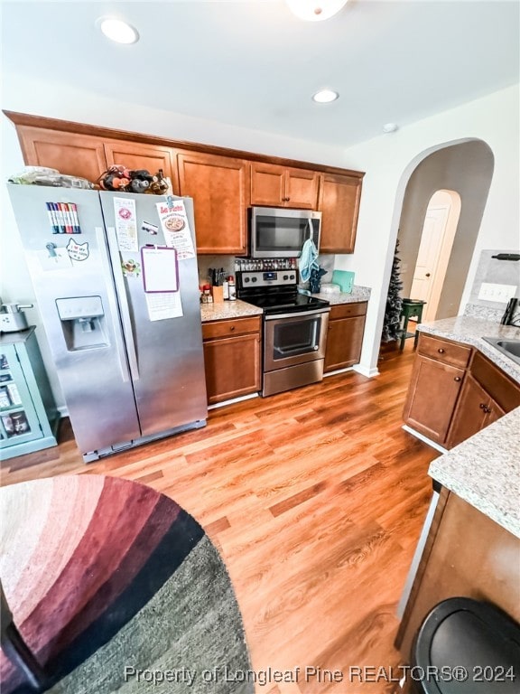 kitchen featuring light hardwood / wood-style flooring, appliances with stainless steel finishes, and sink