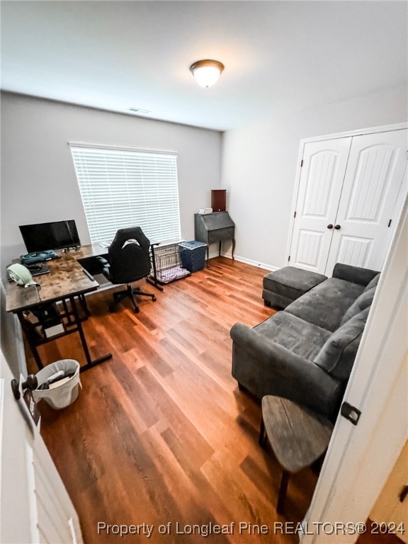 home office with hardwood / wood-style flooring