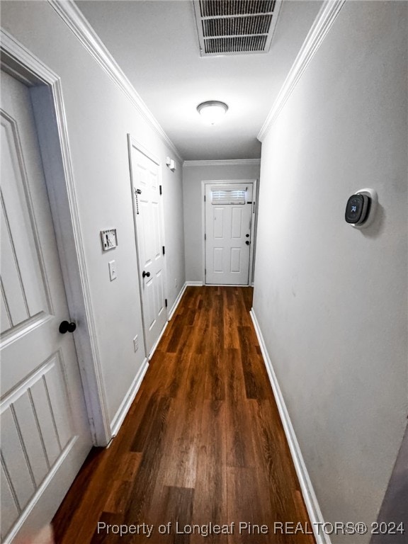 hallway with crown molding and dark wood-type flooring