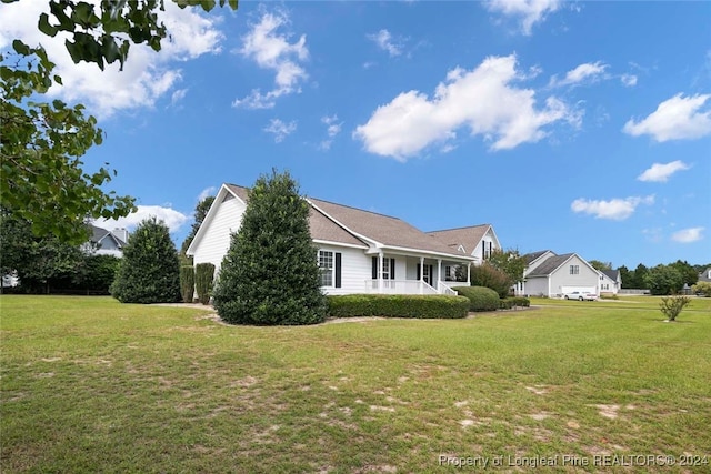 view of side of property with a lawn