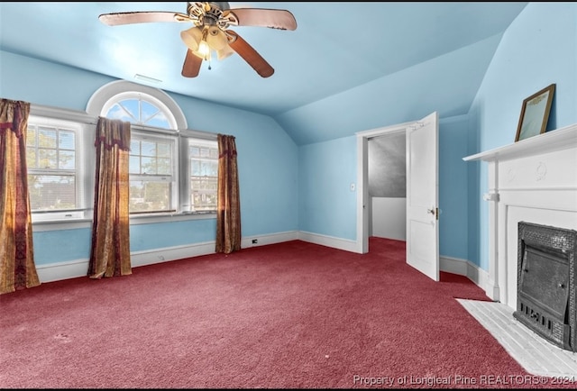 interior space with lofted ceiling, carpet flooring, and ceiling fan