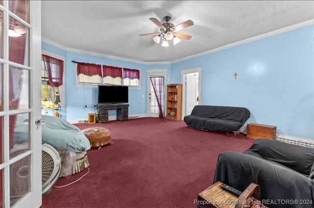 living room featuring a textured ceiling, ceiling fan, carpet floors, and crown molding