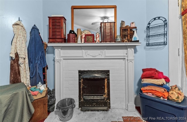 interior details with a brick fireplace and crown molding