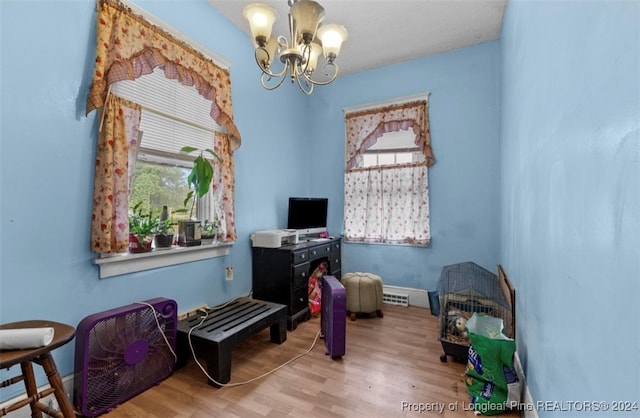 miscellaneous room with a notable chandelier and hardwood / wood-style flooring