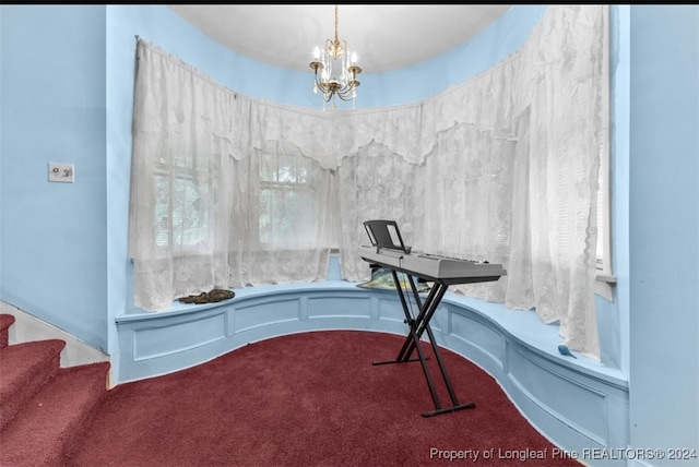 carpeted office space with a chandelier