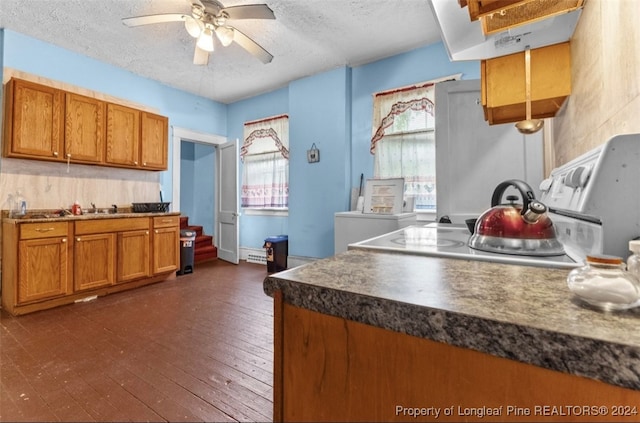 kitchen featuring ceiling fan, range, dark hardwood / wood-style floors, and a textured ceiling