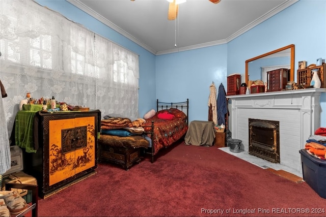 carpeted bedroom featuring ceiling fan, a fireplace, and crown molding